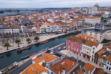 Fototapeta na wymiar drone shot aerial view from above look Aveiro Portugal cloudy day city center rooftops orange red canal streets boats 