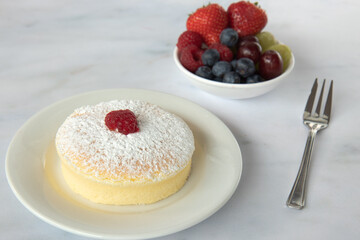 view of a small soft Japanese jiggly cheesecake sponge with powdered sugar on top