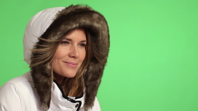 Woman wearing fur hood in wind