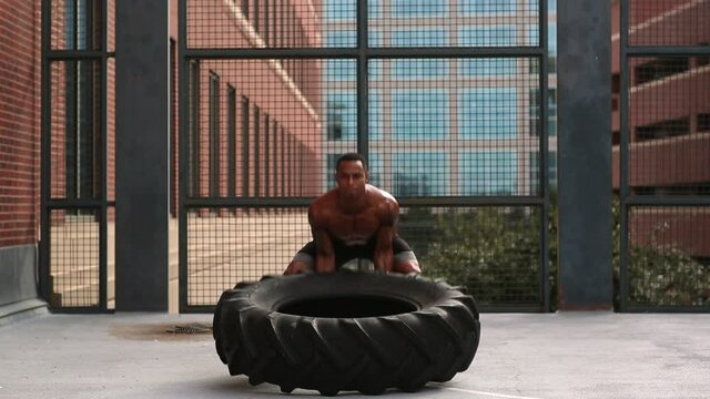 Athlete lifting tire on roof