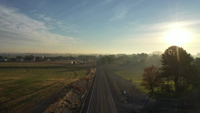 Aerial of school bus driving along highway in rural America