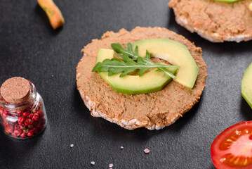 Tasty fresh sandwich with liver paste, avocado pieces and a arugula