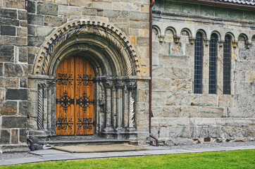 Old wooden door in stone made cathedral in Bergen, Norway