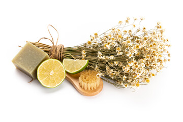 Composition with chamomile flowers and homemade cosmetic, essential oil, sopa,  on white background, top view.