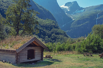 Fototapeta na wymiar Wooden house in the green mountains of Norway