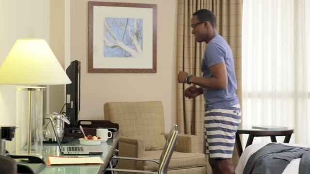 Black man running in place to television in hotel