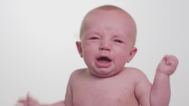 Shirtless Caucasian baby boy crying