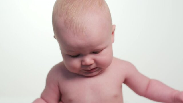 Shirtless Caucasian baby boy crying