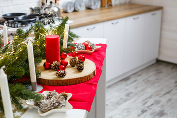 Green Christmas tree, decorated with balls, Christmas decorations, yellow garlands. New Year decorations in the kitchen. New Year. Decorations in the house for Christmas.
