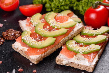 Delicious fresh sandwich with red fish, butter, bread and avocado
