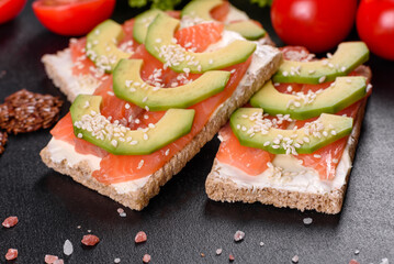 Delicious fresh sandwich with red fish, butter, bread and avocado