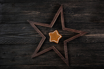 Various christmas gingerbread stars on wooden background