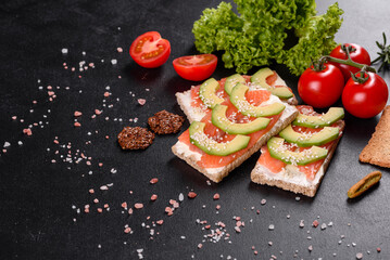 Delicious fresh sandwich with red fish, butter, bread and avocado