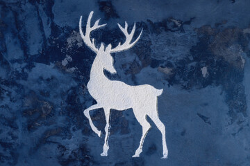 Silhouette of a deer made from flour on dark background