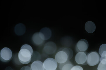 Abstract pattern of bokeh garland lights on black background