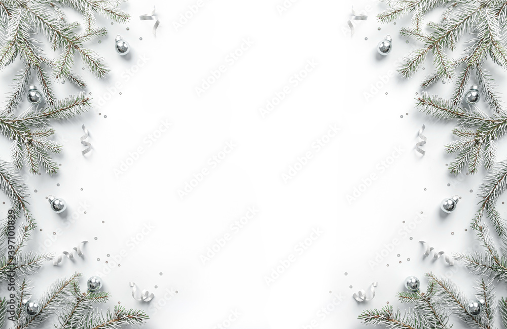 Wall mural Merry Christmas frame made of white fir branches on white background with silver decoration,sparkles, bokeh, light. Xmas and New Year greeting card, winter holiday. Flat lay, top view, banner