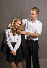 Young man giving his jacket to his girl