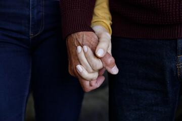 Close up view of senior caucasian couple holding hands at home