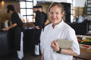 Female chef and divserse group in kitchen