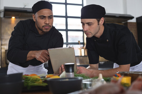 Two divserse male chefs in kitchen