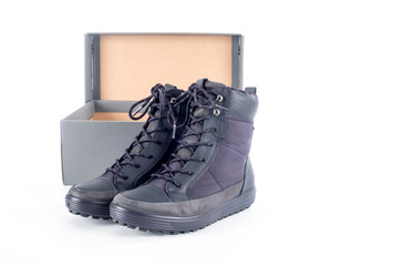 A Pair of Women's New Waterproof Winter Boots and a Shoe Box Isolated on White Background