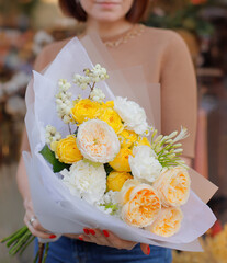 Colorful flowers assorted bouquet in bright paper. Holiday celebration concept. Bouquet of...