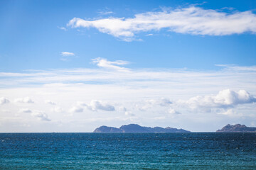 Spain Vigo Praia do Vao beach water waves blue water sky clouds hills mountains Playa de Calzoa Punta elena Enseada de Samil