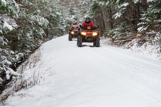 Quads on a snowy trail landscape