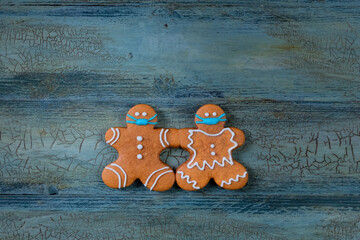 Quarantine from Covid-19. Christmas gingerbread man with a mask
