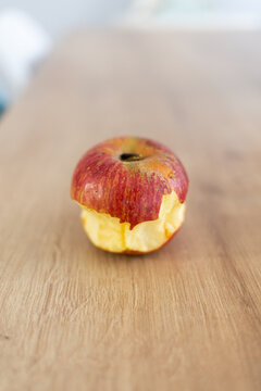 Red biten apple fruit on a wooden table