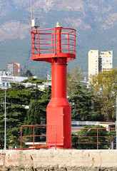 Fototapeta na wymiar Lighthouse on a stone pedestal