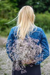 Woman hiding bucket of flowers behind her back