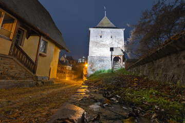 Fototapeta na wymiar Taylor Tower, by night, in the famous medieval town of Transylvania, Sighisoara, Romania