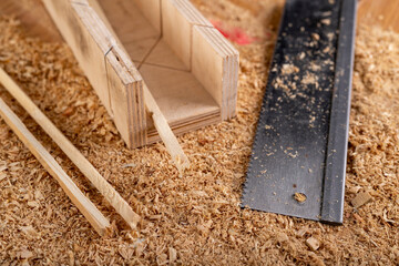 Cutting small pieces of wood with a saw in a carpentry shop. Minor carpentry work in a home workshop.