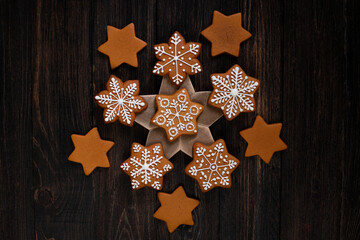 Various christmas gingerbread stars on wooden background