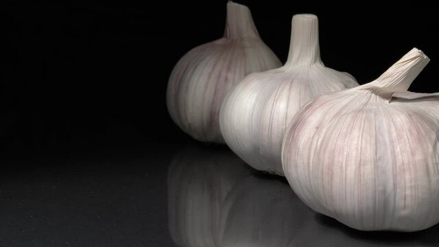 Organic garlic close-up on a black background.