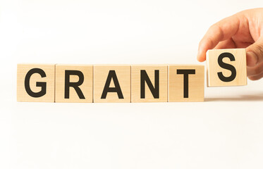 Word grants. Wooden small cubes with letters isolated on white background with copy space available.Business Concept image.