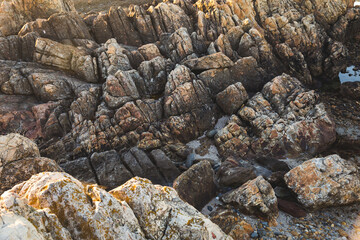 Praia do Coral sunset Viana do Castelo Portugal shore coast beach rocks waves water rocks close up 
