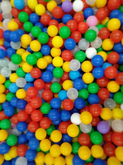 Fototapeta na wymiar Top view of lots of multi-colored plastic balls