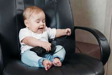 .little baby boy or girl play video game console have fun laugh hold joystick