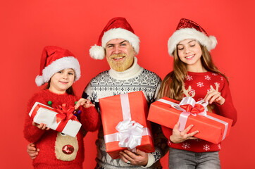 dad love daughters. bearded santa man with kids. knitted fashion for winter. new year shopping. time for presents. happy family celebrate xmas. small girls exchange gifts with father