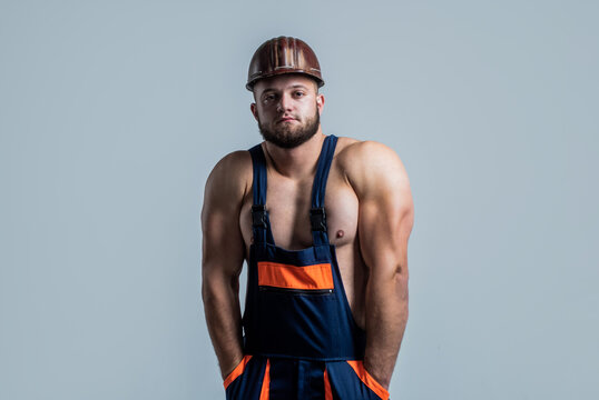muscular man architect with strong body. guy wear worker uniform. athletic builder in helmet. sexy man with body muscles. professional constructor or mechanic. builder engineer
