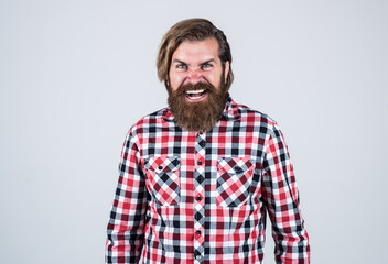 angry handsome bearded guy with unshaven face and stylish hairdo wear casual clothes, anger