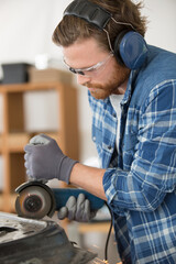 male worker using an angle grinder