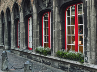 Ancient architecture building with red windows in Brugge, Belgium