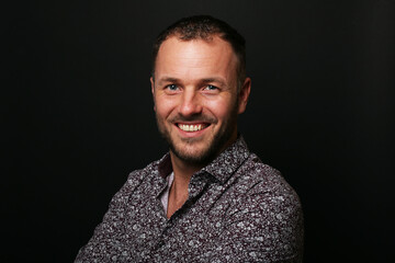 Portrait of a man in front of a colored background