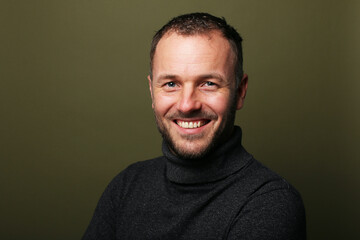 Portrait of a man in front of a colored background