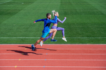 Obraz premium athletic man and sexy woman compete in sprint. male and female coach on stadium running track. healthy lifestyle. marathon speed. sport couple run fast to win. successful fitness sprinters