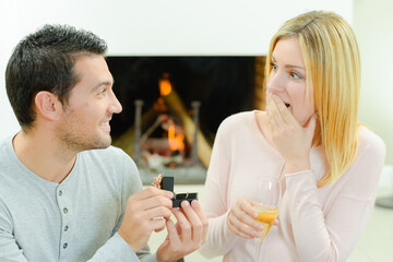 a couple and an engagement ring