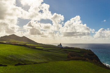 Sao Miguel island Portugal shore lighthouse Atlantic ocean day sunshine sunlight white clouds water...